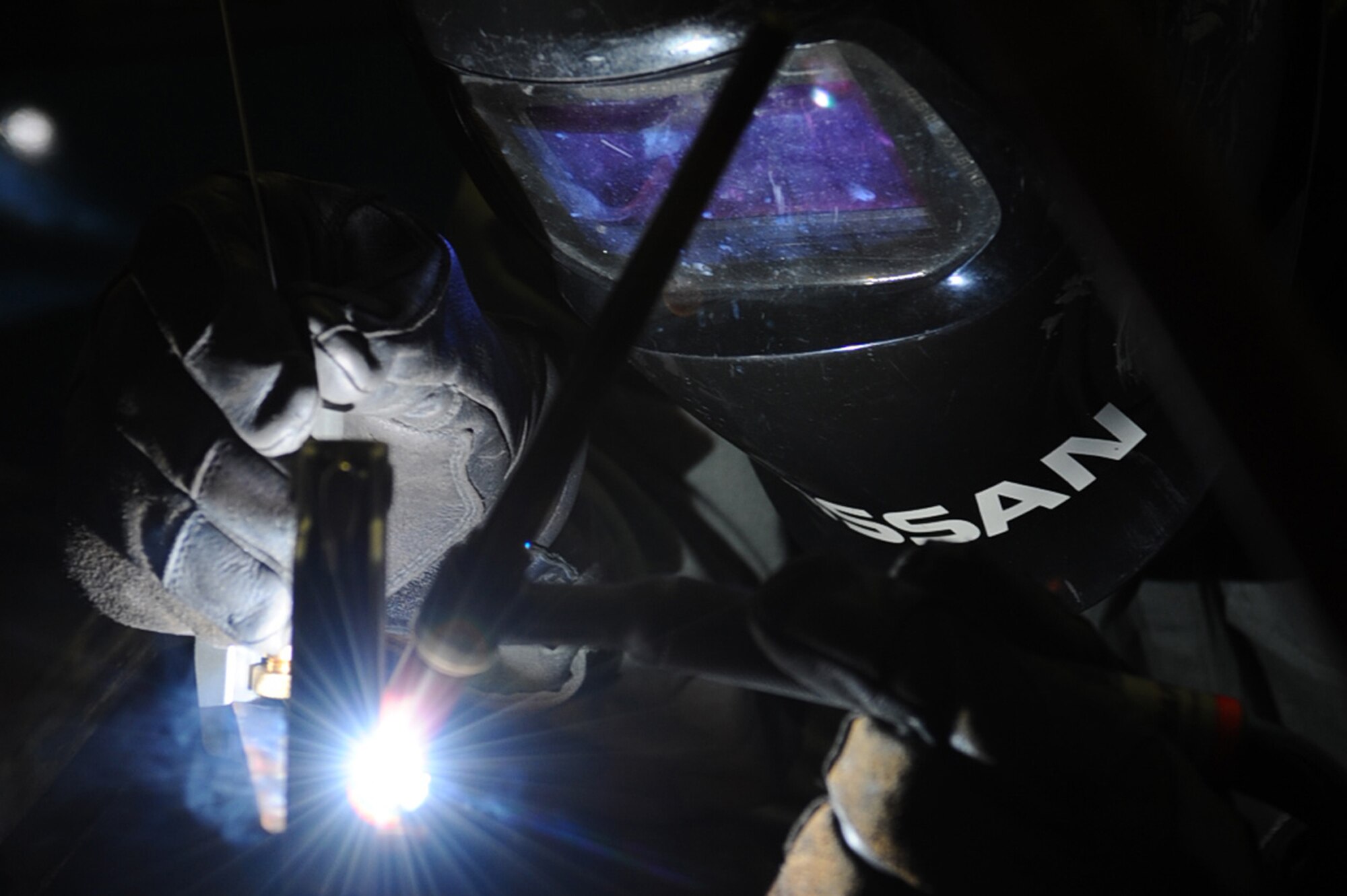 Airman 1st Class Webb Travis, 28th Maintenance Squadron aircraft metals technology technician, uses tungsten inert gas to weld a panel for a bomb loader during repairs at Ellsworth Air Force Base, S.D., Jan. 26, 2011. TIG welding is a precise form of welding that can be performed on a variety of metals. (U.S. Air Force photo/Senior Airman Kasey Close)