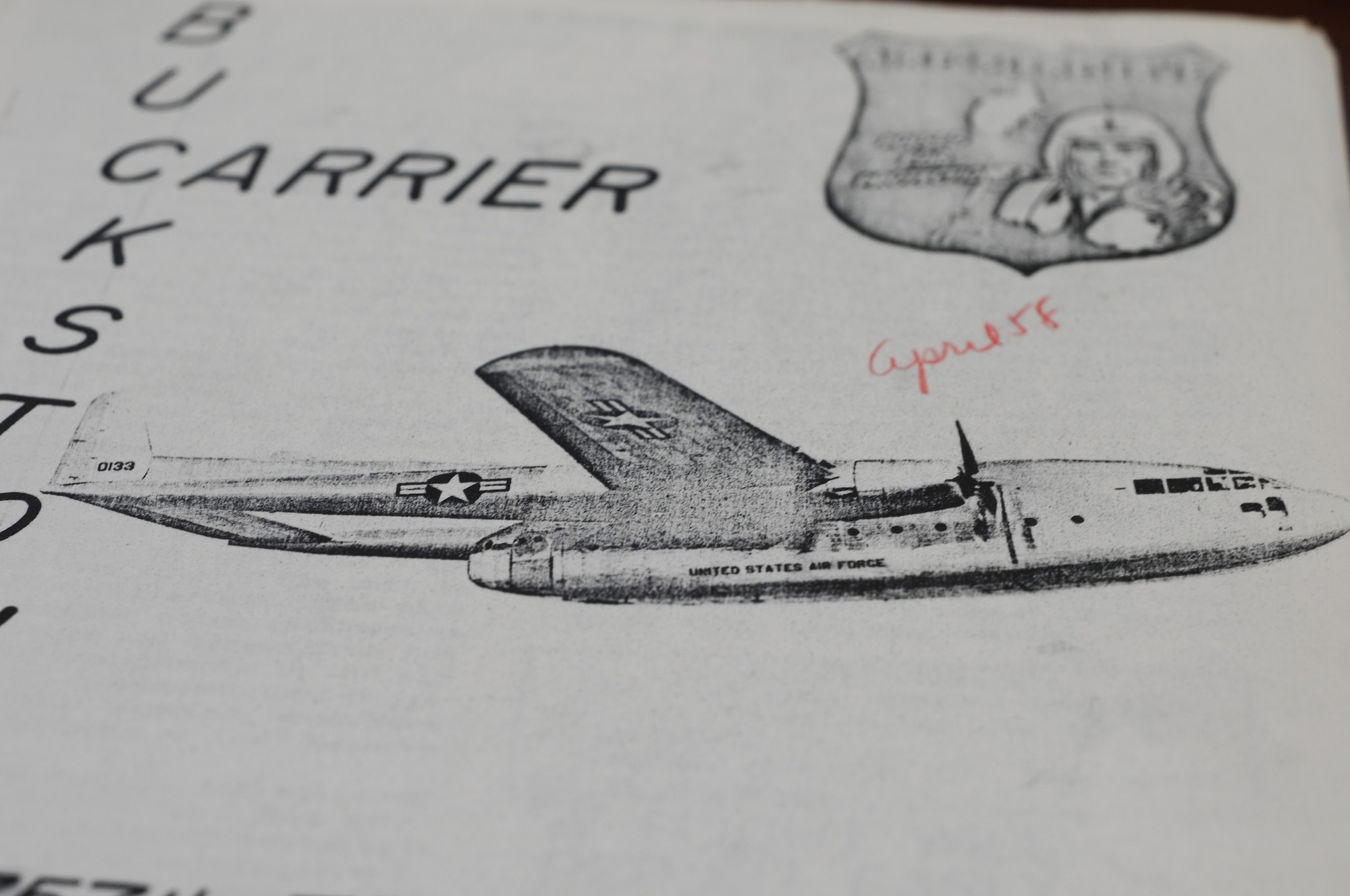 The April 1958 issue of Buckstone Carrier features a sketch of a C-119 "Flying Boxcar," tail number 0133, in flight. U.S. Air Force photo by Mr. Eric M. White