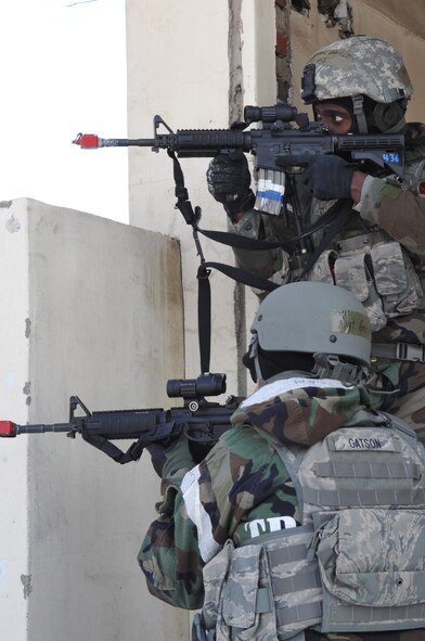 Airman 1st Class Brandon Charles, standing, and Staff Sgt. Brad Gatson, both 51st Security Forces Squadron, respond to a simulated attack near Osan Air Base, Republic of Korea, Jan. 26. The scenario was part of Operational Readiness Exercise Beverly Bulldog 11-01. (U.S. Air Force photo/Tech. Sgt. Stacy Foster)