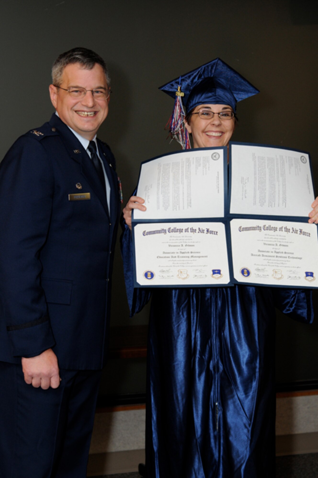 Master Sgt. Veronica Gibson, 442nd Maintenance Group training office noncommissioned officer in charge, receives two Community College of the Air Force Associate of Science degrees - one in Aircraft Armament Systems Technology - one in Education and Training Management - in a ceremony Jan. 9, 2011. Twenty-six other reservists from the 442nd Fighter Wing also received their CCAF degrees in a ceremony officiated by Col. Alan Teauseau, 442nd Mission Support Group commander. The 442nd Fighter Wing is an A-10 Thunderbolt II Air Force Reserve unit at Whiteman Air Force Base, Mo. (U.S. Air Force photo/Staff Sgt. Jonathan Adams)