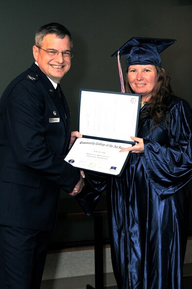 Master Sgt. Linda Jobe, 442nd Maintenance Group, receives her Community College of the Air Force Associate of Science degree in Information management in a ceremony Jan. 9, 2011. Twenty-six other reservists from the 442nd Fighter Wing also received their CCAF degrees in a ceremony officiated by Col. Alan Teauseau, 442nd Mission Support Group commander. The 442nd Fighter Wing is an A-10 Thunderbolt II Air Force Reserve unit at Whiteman Air Force Base, Mo. (U.S. Air Force photo/Staff Sgt. Jonathan Adams)