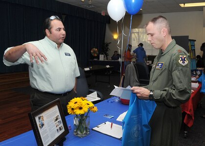 Lupe Castaneda, left, a behavior analyst with Pedicatric Rehabilitation and Behavioral Services of San Antonio, talks with Major Jed Bredemus, an instructor pilot with the 99th Flying Training Squadron on Jan. 26 at Randolph Air Force Base.  The two were at the Information Fair for Exceptional Family Members, sponsored by the Airman and Family Readiness Center at Randolph Air Force Base.
(U.S. Air Force photo/David Terry)