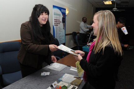 Krista Graham, left, with Partners Resource Network, hands a brochure explaining her organizations services to Molly Mercer, a management trainee with the Child Development Center at Randolph Air Force Base. The booth was part of the Information Fair held on Jan 26. for Exceptional Family Members, sponsored by the Airman and Family Readiness Center at Randolph Air Force Base.
(U.S. Air Force photo/David Terry)