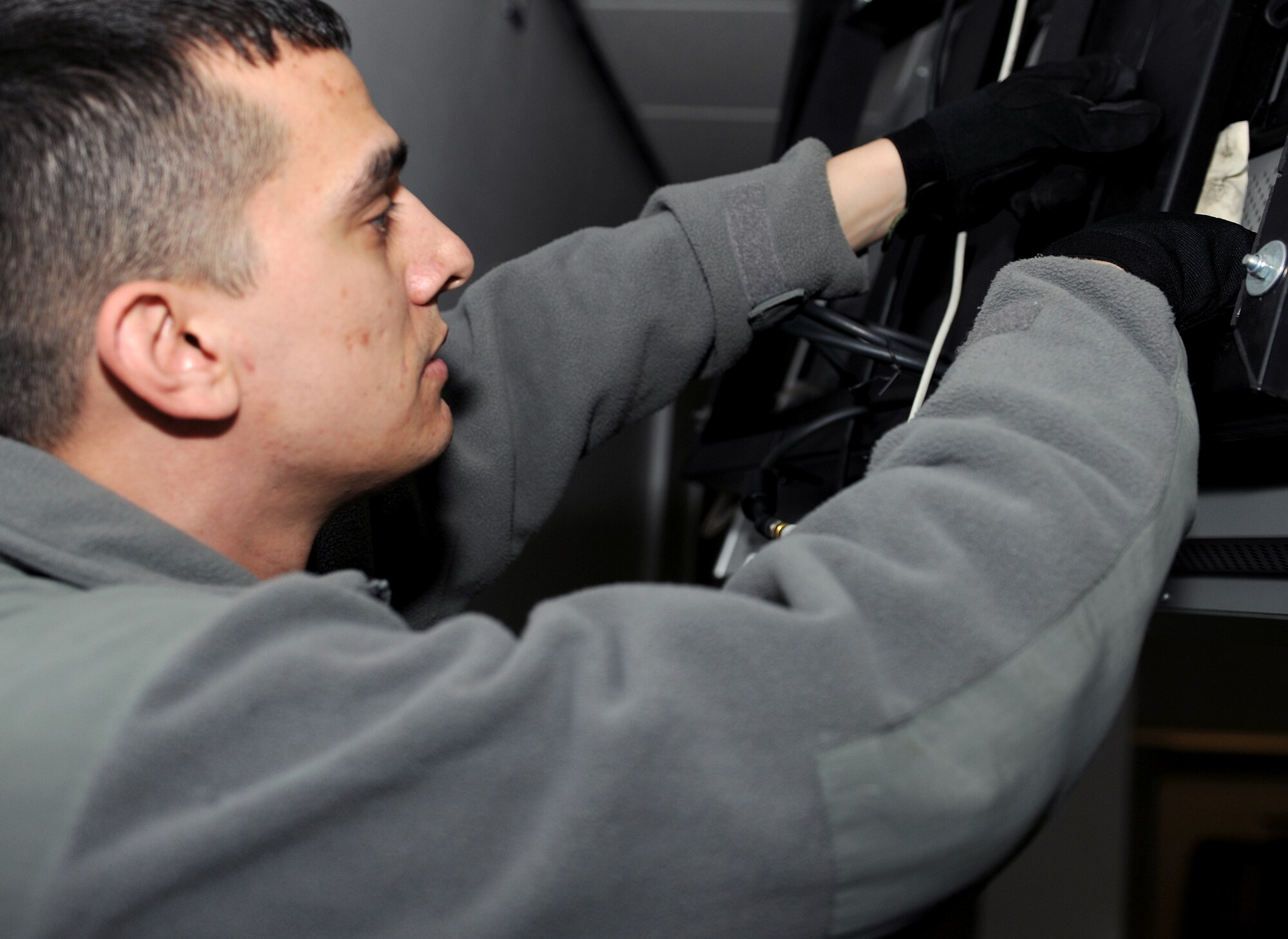 RAF MILDENHALL, England -- Staff Sgt. Philip Bradt, 100th Security Forces Squadron military working dog trainer, plants a training aid in the passenger terminal here Jan. 27, 2011.  These training aids are used to keep patrol detection dogs proficient. (U.S. Air Force photo/Senior Airman Tabitha M. Lee)
