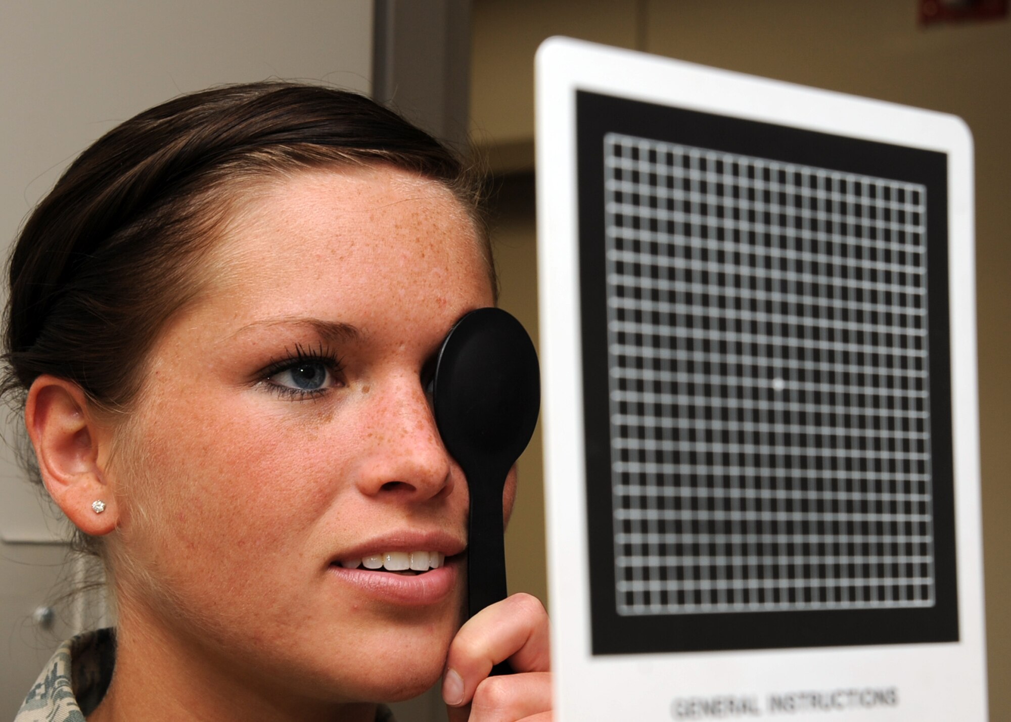 Airman 1st Class Shawna Lake, 22nd Medical Support Squadron information systems administrator  receives a near vision examination at the optometry clinic, Jan. 25, 2011, McConnell Air Force Base, Kan. The McConnell optometry clinic is the only eye clinic for McConnell beneficiaries, so they keep a high daily ops tempo. (U.S. Air Force photo/Staff Sgt. Dallas Edwards)