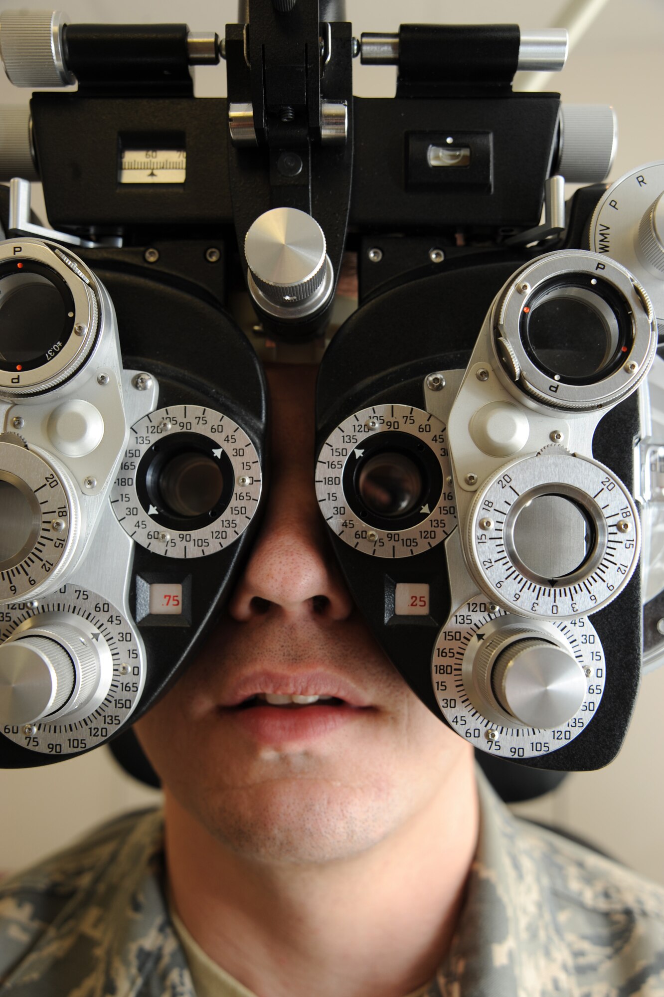 Staff Sgt. Michael Schocker, 22nd Air Refueling Wing broadcaster, looks through a phoropter at the optometry clinic, Jan. 25, 2011, McConnell Air Force Base, Kan. The phoropter is a device with several lenses that helps the optometrist determine a patient’s eyeglass prescription. McConnell’s optometry clinic accepts appointments from Airmen and their dependants for routine eye exams and eye care. (U.S. Air Force photo/Staff Sgt. Dallas Edwards)