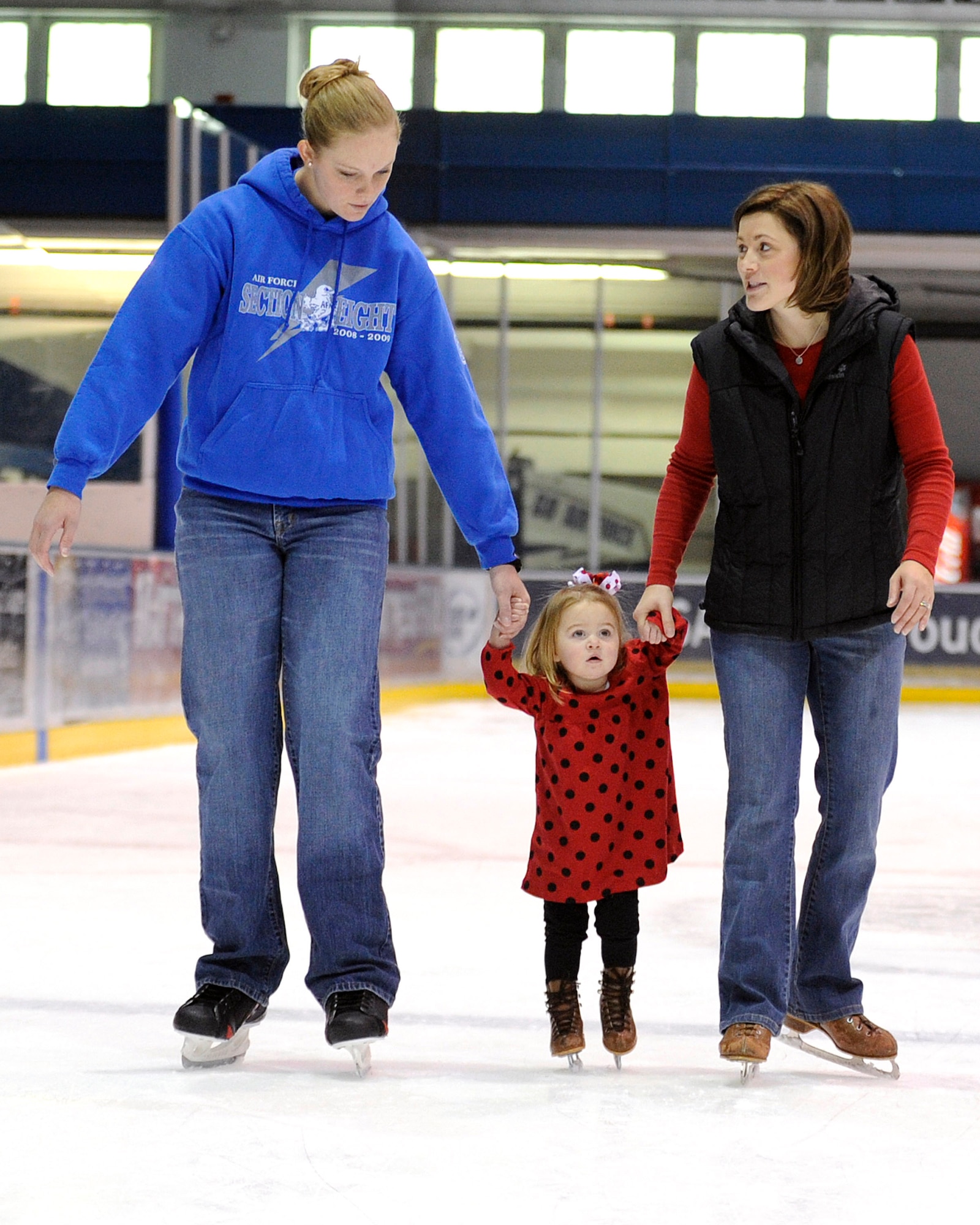 Mary Katherine Harrison, center, skates at the Cadet Ice Arena Jan. 22, 2011, with help from her mother, Megan Harrison, right, and Cadet 2nd Class Nichole Stilwell. More than 100 family members from Fort Carson, Colo., came to the Air Force Academy for a day out at the invitation of cadets as part of the Leaders in Flight Today program. Mary Katherine is the daughter of Army 1st Lt. Daniel Harrison. (U.S. Air Force photo/Mike Kaplan)