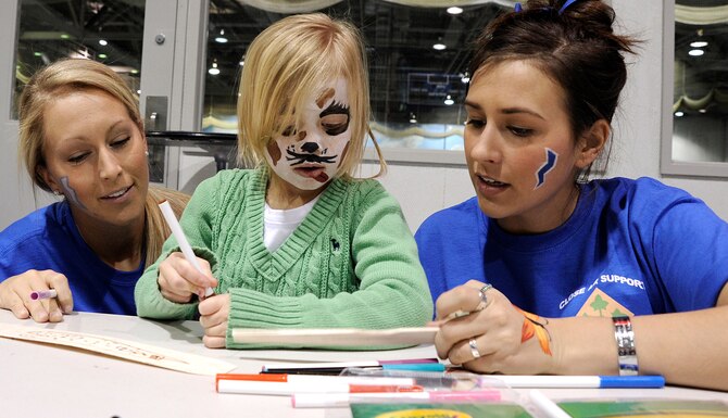 Cadet 3rd Class Layne Harrod, left, and Cadet 2nd Class Chelsaa Ragland, right, help Oakley Gardner build a balsa glider during a Leaders in Flight Today program outing at the Cadet Field House Jan. 22, 2011. Oakley is the daughter of Army Staff Sgt. Erich Gardner, who is stationed at Fort Carson, Colo. (U.S. Air Force photo/Mike Kaplan)