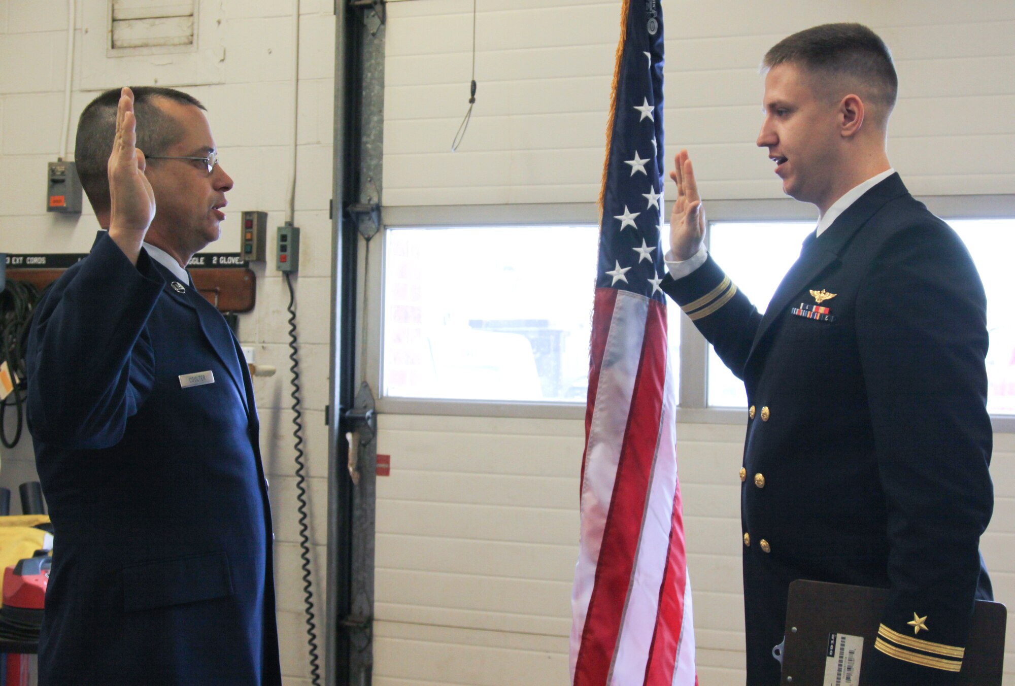 Navy Lieutenant Sean Hovanec reenlists his uncle, Tech. Sgt. Frank Coulter, Jan. 11, 2011.  Sergeant Coulter has been a member of the armed services since 1984. (US Air Force Photo/Airman 1st Class Melissa Knox)