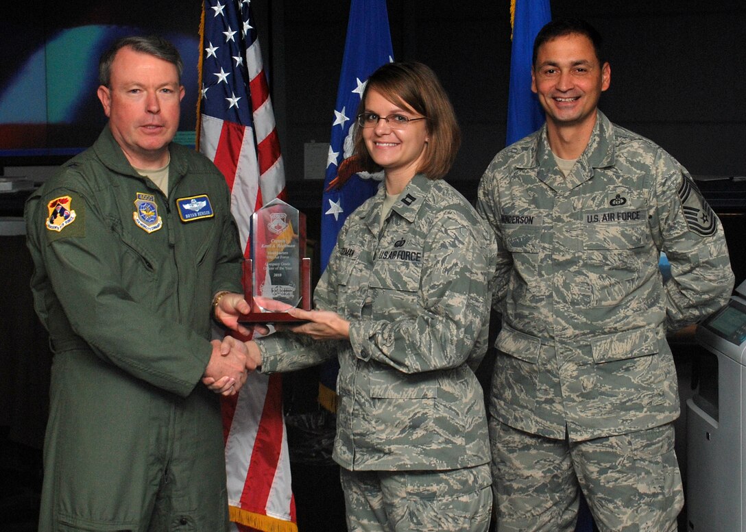 SCOTT AIR FORCE BASE, IL. -- Brig Gen. Bryan Benson (left), 18th Air Force vice commander, and Chief Master Sgt. Andrew Henderson (right), 618th Air and Space Operations Center (Tanker Airlift Control Center) superintendent, present the Headquarters, 18th Air Force Company Grade Officer of the Year award to Capt. Kerri Rochman here Jan. 20. Capt. Rochman is from the Headquarters, 18th Air Force staff here. (U.S. Air Force Photo by Capt Justin Brockhoff)