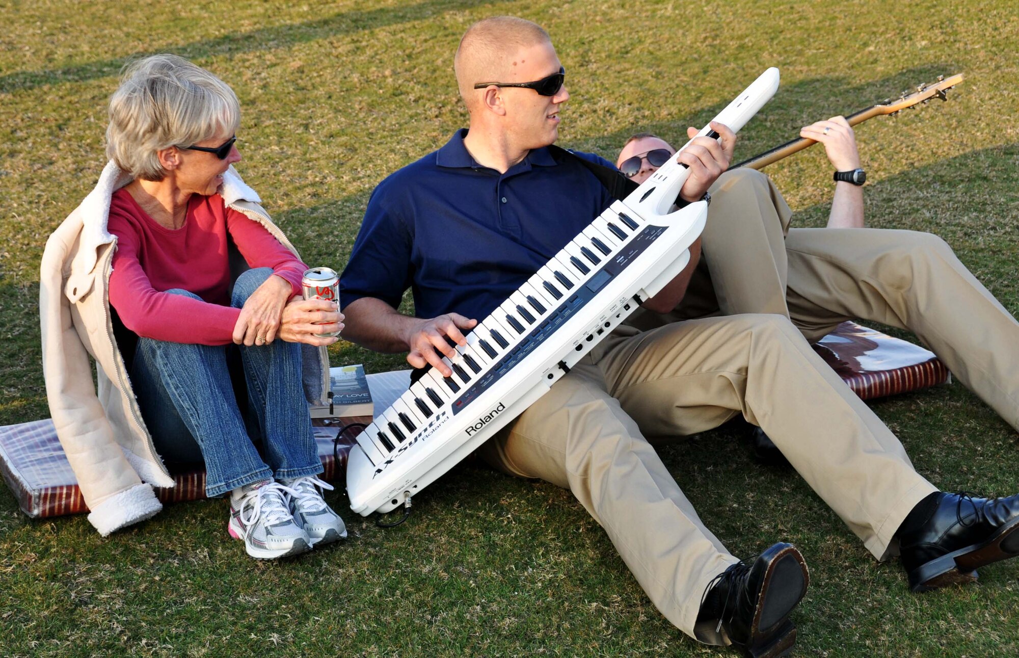 Senior Airman Adam Braatz, pianist for the U.S. Air Forces Central Band, "Starlifter," serenades an audience member during a performance at the Texas A&M campus in Southwest Asia, Jan. 22. (U.S. Air Force photo/Staff Sgt. Anthony T. Graham)
