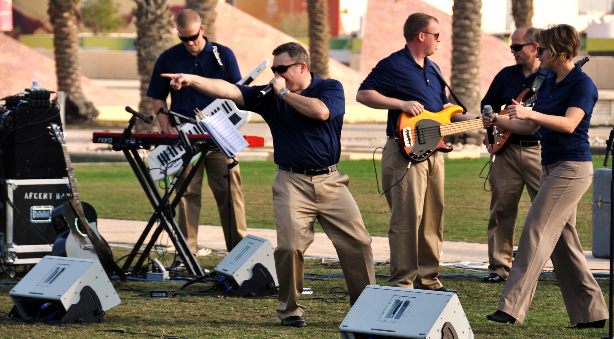 Tech. Sgt. Jamie Gilley, vocalist for the U.S. Air Forces Central Band, "Starlifter," joins with the rest of the band to entertain the crowd during a performance at the Texas A&M campus in Southwest Asia, Jan. 22. (U.S. Air Force photo/Staff Sgt. Anthony T. Graham) 
