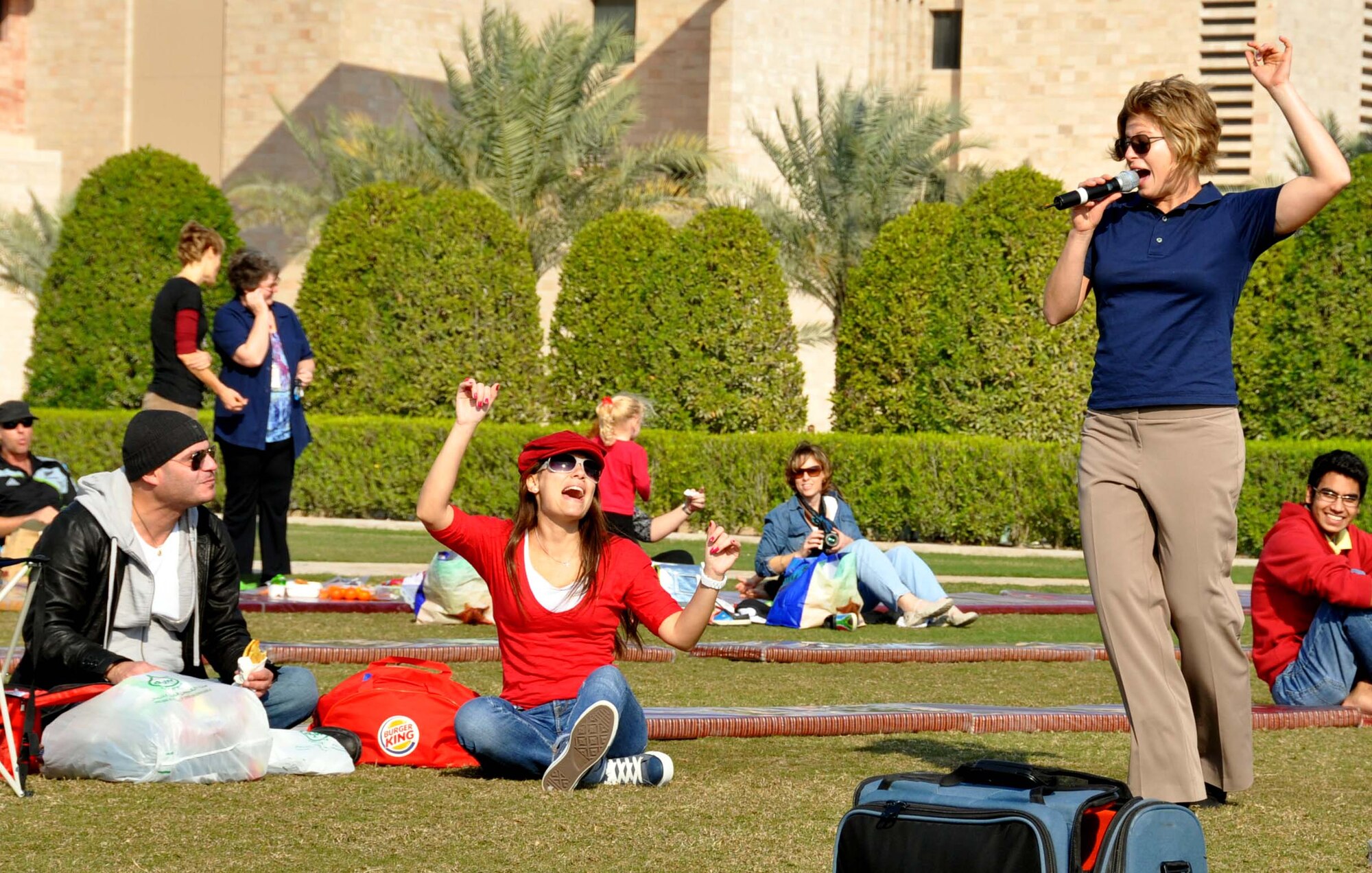 Airman 1st Class Carmen Emborski, vocalist of the U.S. Air Forces Central Band, "Starlifter," entertains a crowd of students at the Texas A&M campus while performing with the band Jan. 22, in Southwest Asia. (U.S. Air Force photo/Staff Sgt. Anthony T. Graham)
