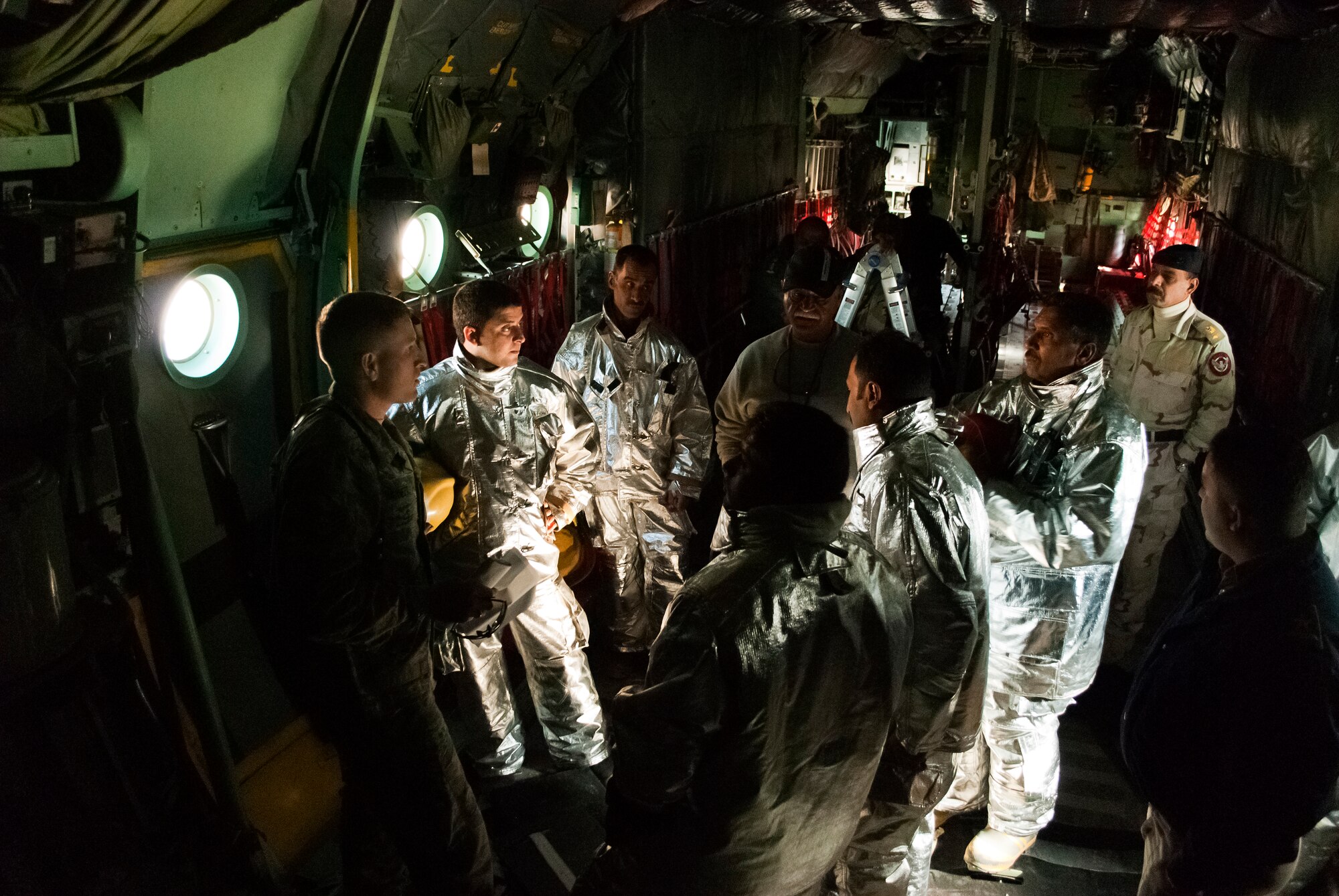 Tech. Sgt. Todd Barnett, Iraq Training and Advisory Mission-Air advisor, explains safety procedures during a class on a C-130 Hercules at New Al-Muthana Air Base, Iraq, January 24.  The familiarization class was intended to broaden the depth of knowledge and experience for Iraqi Air Force firefighters. (U.S. Air Force photo by Tech. Sgt. Amy Everhard, released)