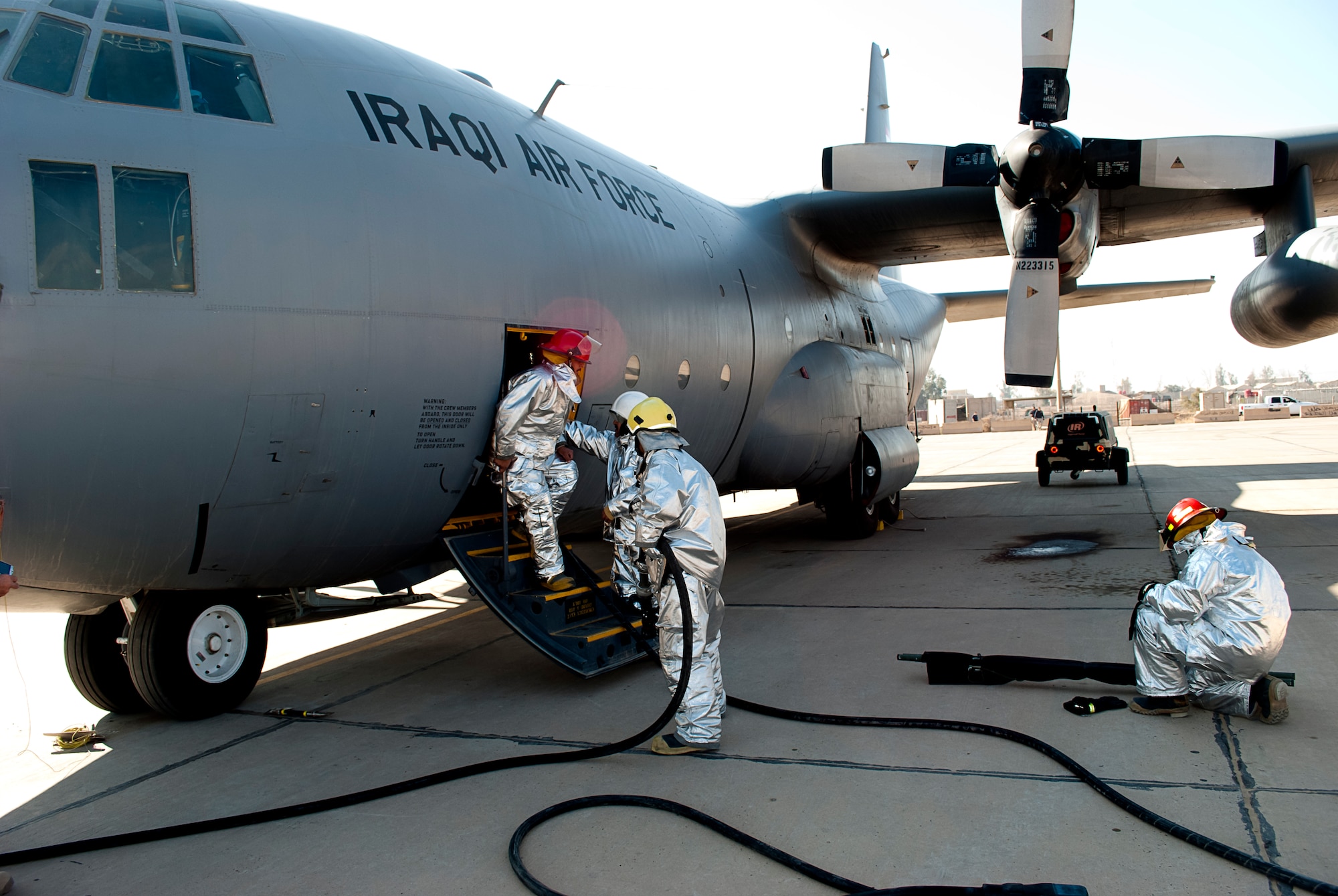 Iraqi Air Force firefighters at New Al-Muthana Air Base, Iraq, hone their skills during a C-130 Hercules class January 24.  The class was geared towards expanding IqAF firefighter knowledge and response capabilities. (U.S. Air Force photo by Tech. Sgt. Todd Barnett, released)