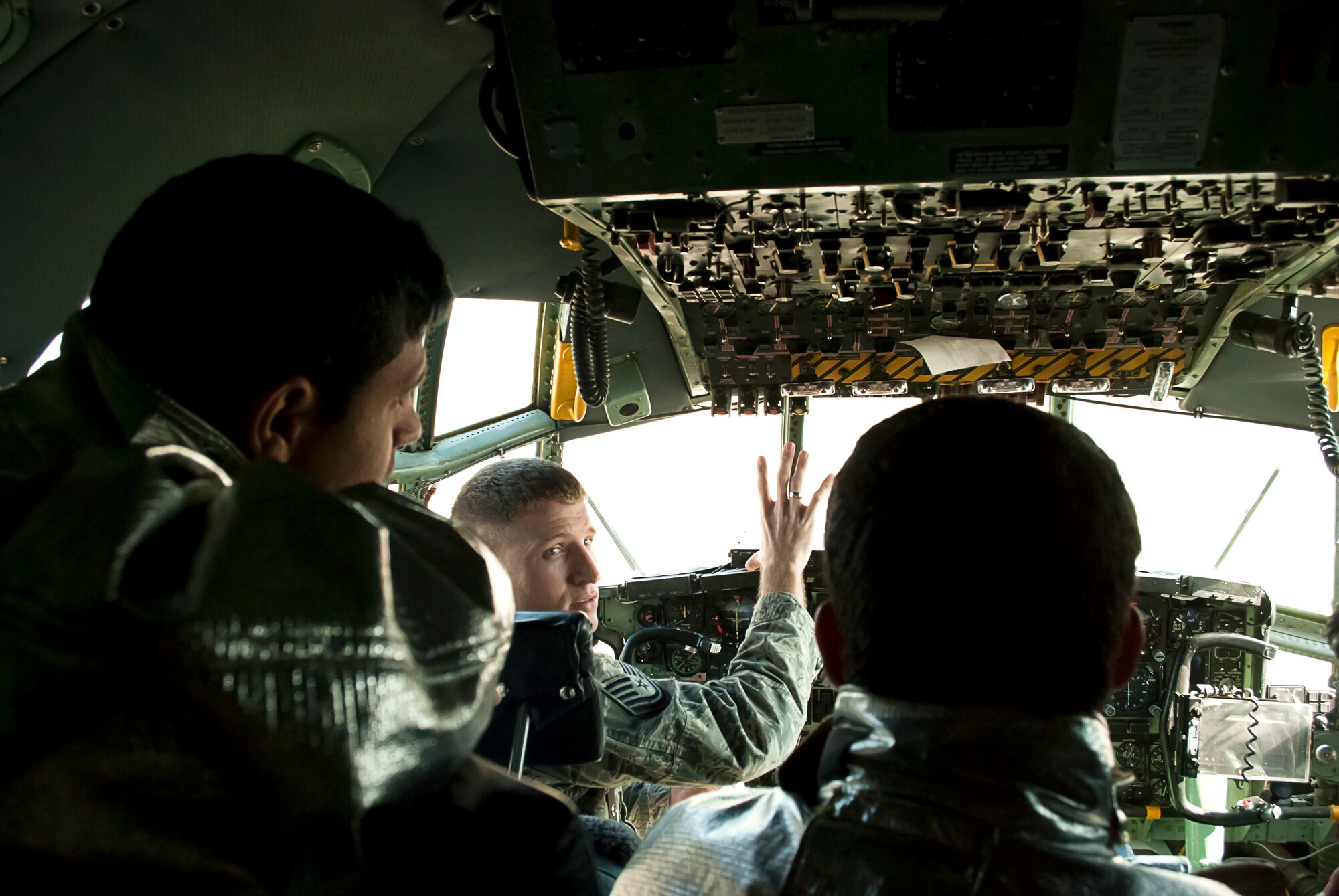 Tech. Sgt. Todd Barnett, Iraq Training and Advisory Mission-Air  advisor, explains emergency shutdown procedure on a C-130 Hercules at New Al-Muthana Air Base Iraq, January 24.  The familiarization class was intended to broaden the depth of knowledge and experience for Iraqi Air Force firefighters. (U.S. Air Force photo by Tech. Sgt. Amy Everhard, released)