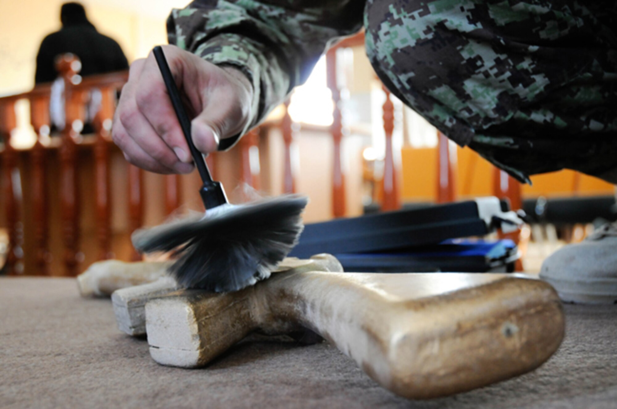 HERAT, Afghanistan -- An Afghan National Army military policeman dusts a mock M-16 rifle for finger prints during a training scenario at Camp Zafar, Herat Province, Afghanistan, Jan. 17, 2011. Dusting for prints was one of many skills that 12 ANA officers learned during the first-ever ANA two-week Criminal Investigation Basic Course, which graduated Jan. 19. (U.S. Air Force photo/Airman 1st Class Lausanne Morgan)