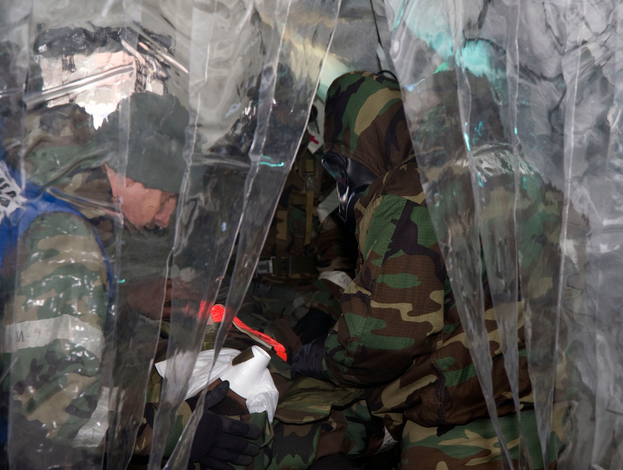 A U.S Air Force evaluation exercise team member watches medics from the 35th Medical Group care for an injured patient Jan. 27, 2011, at Misawa Air Base, Japan. EET members are selected from within their AFSC in an effort to ensure accurate evaluations. (U.S. Air Force photo by Tech. Sgt. Russell McBride/Released)