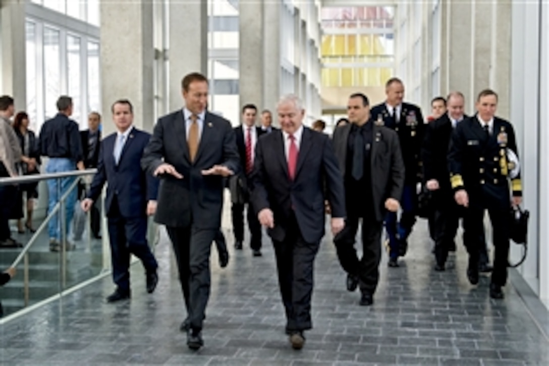 U.S. Defense Secretary Robert M. Gates walks with Canadian Defense Minister Peter MacKay at the Old City Hall in Ottawa, Canada, Jan. 27, 2011.  Gates visited Canada to attend bilateral meetings with his counterparts from Canada. The two leaders discussed a variety of defense issues, including Afghanistan.