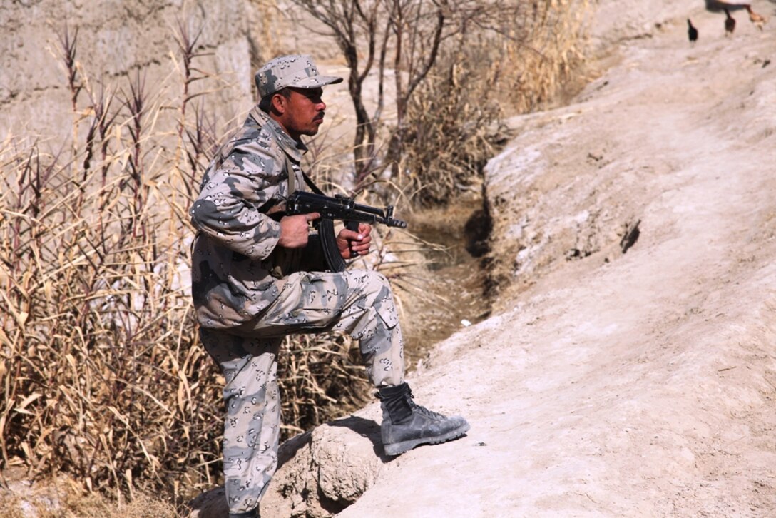 An Afghan Border Patrolman provides security during a patrol, Jan. 27, 2011. The ABP, combined with Marines of 3rd Light Armored Reconnaissance Battalion, 1st Marine Division (Forward), talked to locals about Taliban activity in the area.