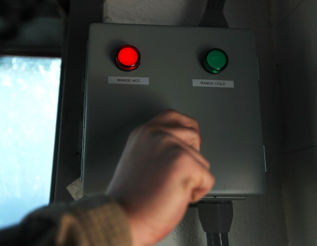 A pit noncommissioned officer changes a switchboard from ‘Range Cold’ to ‘Range Hot,’ which is a unique component of the recently implemented pit alarm sensor systems at the Alpha, Bravo and Charlie Ranges aboard Marine Corps Base Camp Lejeune, Jan. 25. The new systems were introduced after an incident in 2009 and enforce safety by taking pit precautions a little further than the ‘red line.’