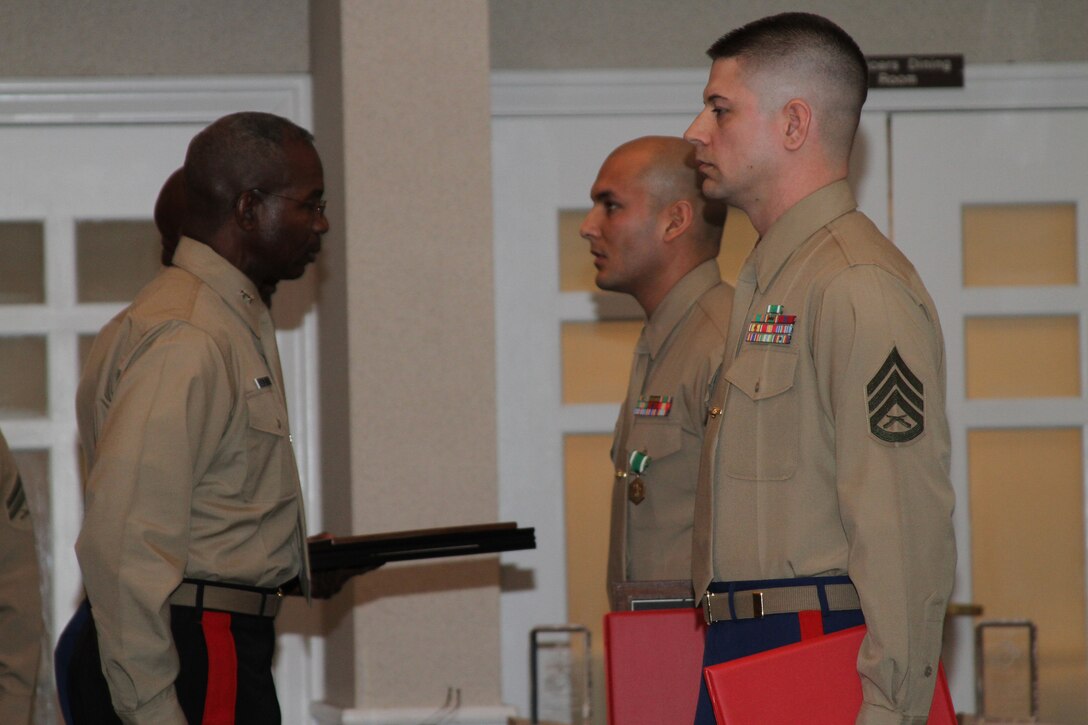 Staff Sgt.’s Gerson G. Ruiz and Brandon L. Johnson are presented awards by Maj. Gen. Ronald L. Bailey, commanding general, Marine Corps Recruiting Command, after being named MCRC’s recruiter and prior service recruiter of the year during the Commandant’s 2010 Combined Awards Ceremony Jan. 28. Both were meritoriously promoted to gunnery sergeant during the ceremony. Ruiz, from Recruiting Station Frederick, Md., 4th Marine Corps District, was the recruiter of the year. Johnson, from Prior Service Recruiting Station Four, 4th Marine Corps District, was the prior service recruiter of the year.