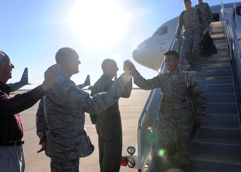 DYESS AIR FORCE BASE, Texas – An Airman departing an aircraft following a deployment hi-fives Col. David Been, 7th Bomb Wing commander, Jan 27 here. The Airman was deployed to Southwest Asia in support of Operations New Dawn and Enduring Freedom. (U.S. Air Force photo/ Senior Airman Jenifer H. Calhoun)