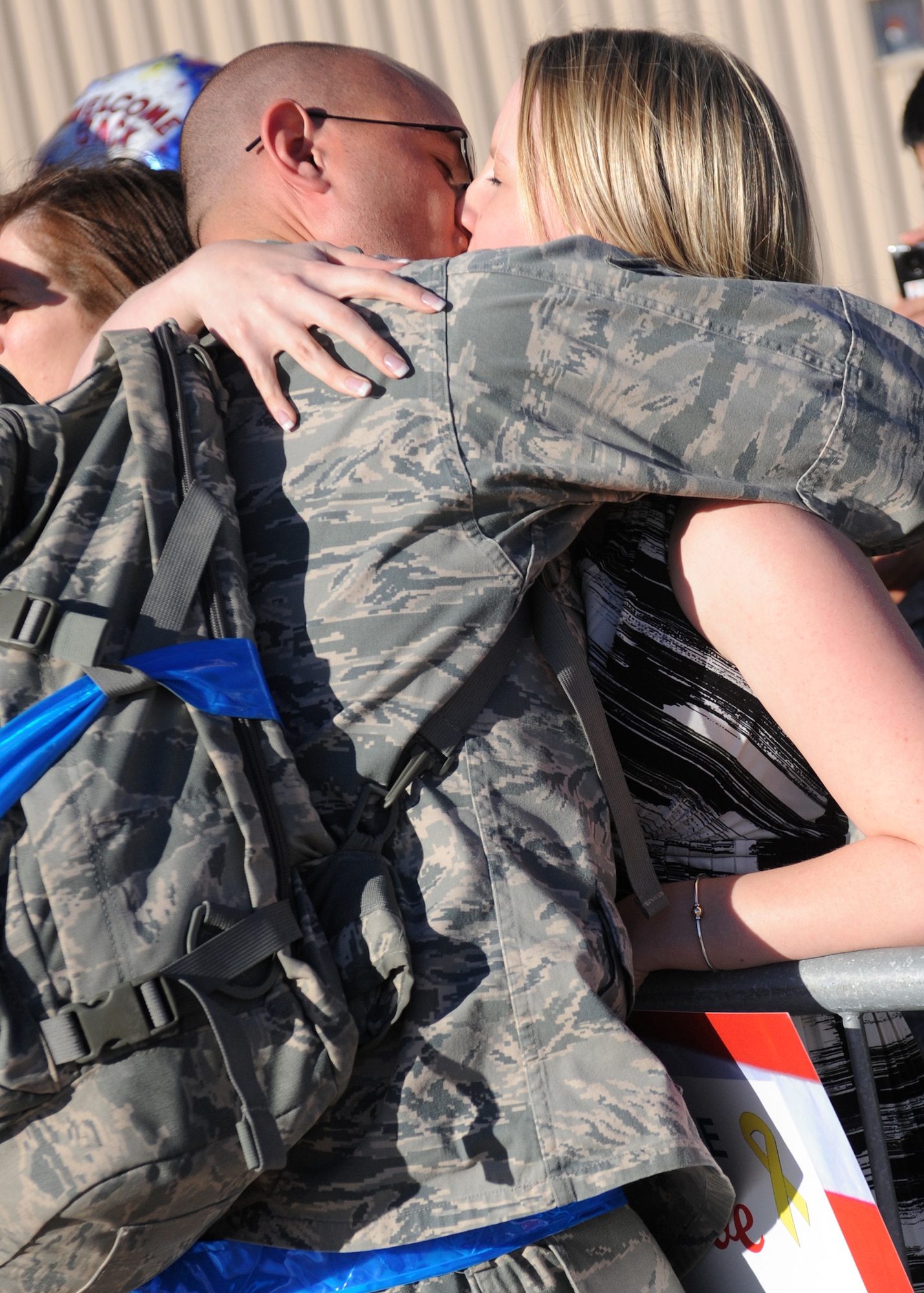 DYESS AIR FORCE BASE, Texas – Senior Airman Craig Struck, 7th Aircraft Maintenance Squadron, kisses his wife, Sammi, Jan. 27 here upon arrival from a deployment. Airman Struck was deployed to Southwest Asia in support of Operations New Dawn and Enduring Freedom. (U.S. Air Force photo/ Senior Airman Jenifer H. Calhoun)