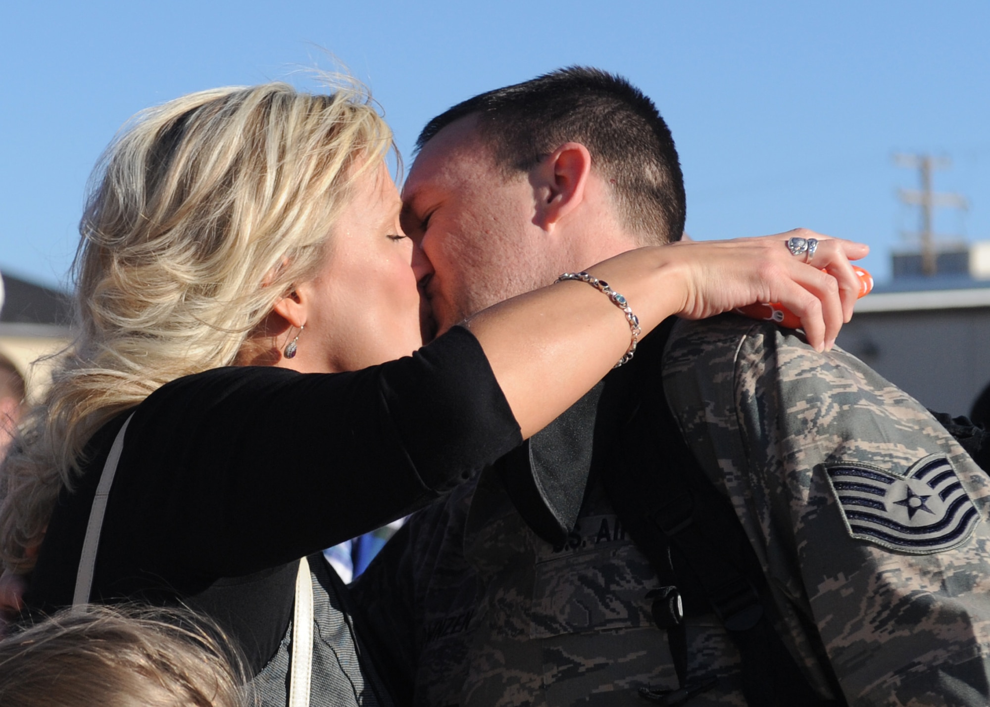 DYESS AIR FORCE BASE, Texas – Jennifer Townsend kisses her husband, Tech. Sgt. Richard Townsend, 7th Equipment Maintenance Squadron, Jan. 27 here upon arrival from a deployment. Sergeant Townsend was deployed to Southwest Asia in support of Operations New Dawn and Enduring Freedom. (U.S. Air Force photo/ Senior Airman Jenifer H. Calhoun)