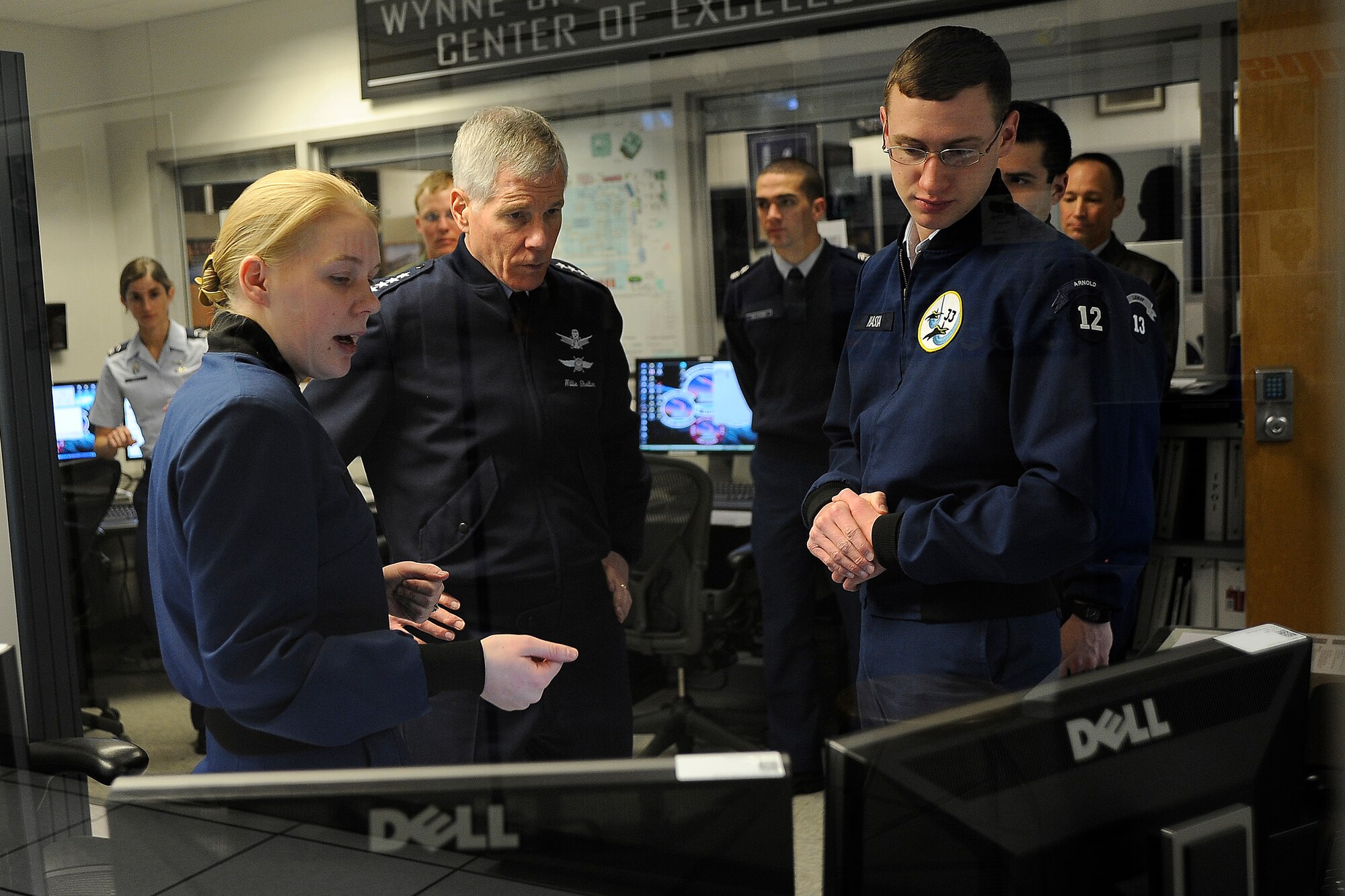 Cadet 1st Class Kathryn Blythe (left) and Cadet  2nd Class Chris Hassa (right) explain FaclonSAT-5 operations to Gen. William Shelton during his visit to the Academy's Department of Astronautics Jan. 24, 2011. General Shelton, the commander of Air Force Space Command and a 1976 Academy graduate who majored in astronautical engineering, received briefings on the FalconSAT and FalconLAUNCH programs at the Academy. Cadet Blythe is the FalconSAT-5 program manager, and Cadet Hassa is a FalconSAT-5 satellite operator. (U.S. Air Force photo/Rachel Boettcher)
