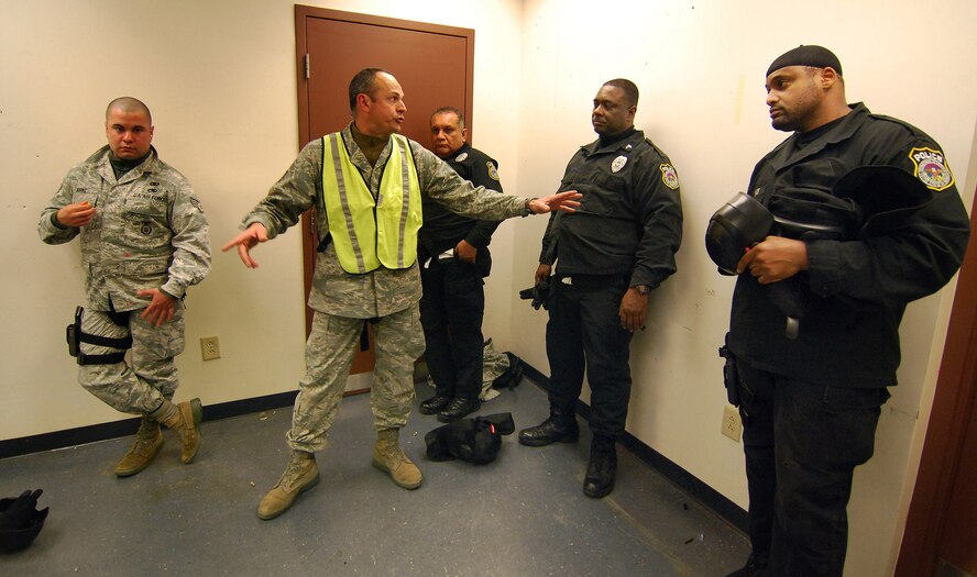 Tech Sgt. Francisco Martinez, an Instructor from the 610th Security Forces
Squadron, Joint Reserve Base Fort Worth, Texas, critiques the response team's performance during a scenario for the Basic Active Shooter Course, Jan 27.  The 4-man training team came to Dobbins Air Reserve Base to provide this critical training for the 94th Security Forces Squadron and other Dobbins area security personnel.  The two day course provides classroom and tactical instruction to first responders covering several shooting spree scenarios.  Response team members from the 94th Security Forces Squadron are Staff Sgt. William Burke, Officer Juan Medina, Officer Kenneth Hudson and Officer Edward Savage.   (U.S. Air Force photo/ Brad Fallin)
