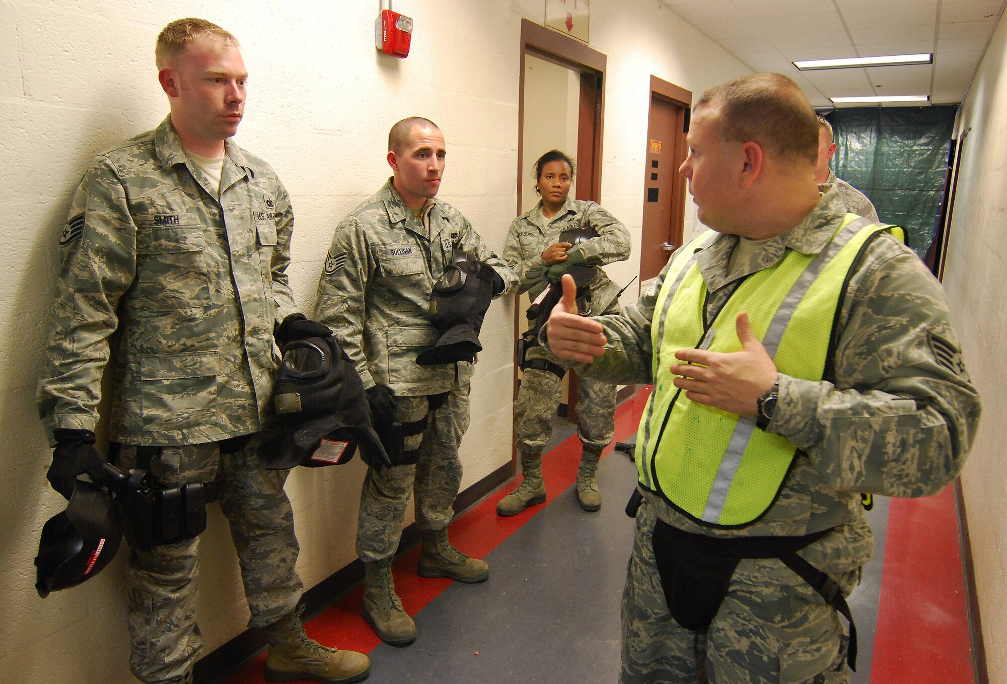 Staff Sgt. Stacey James, an Instructor from the 610th Security Forces Squadron,
 Joint Reserve Base Fort Worth, Texas, critiques the response team's performance during a scenario for the Basic Active Shooter Course, Jan 27.  The 4-man training team came to Dobbins Air Reserve Base to provide this critical training for the 94th Security Forces Squadron and other Dobbins area security personnel.  The two day course provides classroom and tactical instruction to first responders covering several shooting spree scenarios.  Response team members from the 94th Security Forces Squadron are Staff Sgt. Tommy Smith, Staff Sgt. Daniel Sullivan and Tech Sgt. Doreen Clark-Blake.   (U.S. Air Force photo/ Brad Fallin)
