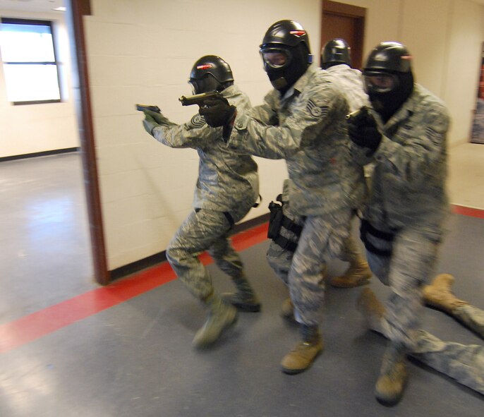 Another 4-person response team advances in a tactical formation down a hallway looking for the "shooter" during the Basic Active Shooter Course provided by personnel from the 610th Security Forces Squadron, Joint Reserve Base Fort Worth, Texas, Jan 27.  The team came to Dobbins Air Reserve Base to provide this critical training for the 94th Security Forces Squadron and other Dobbins area security personnel.  The two day course provides classroom and tactical instruction to first responders covering several shooting spree scenarios.   (U.S. Air Force photo/ Brad Fallin)