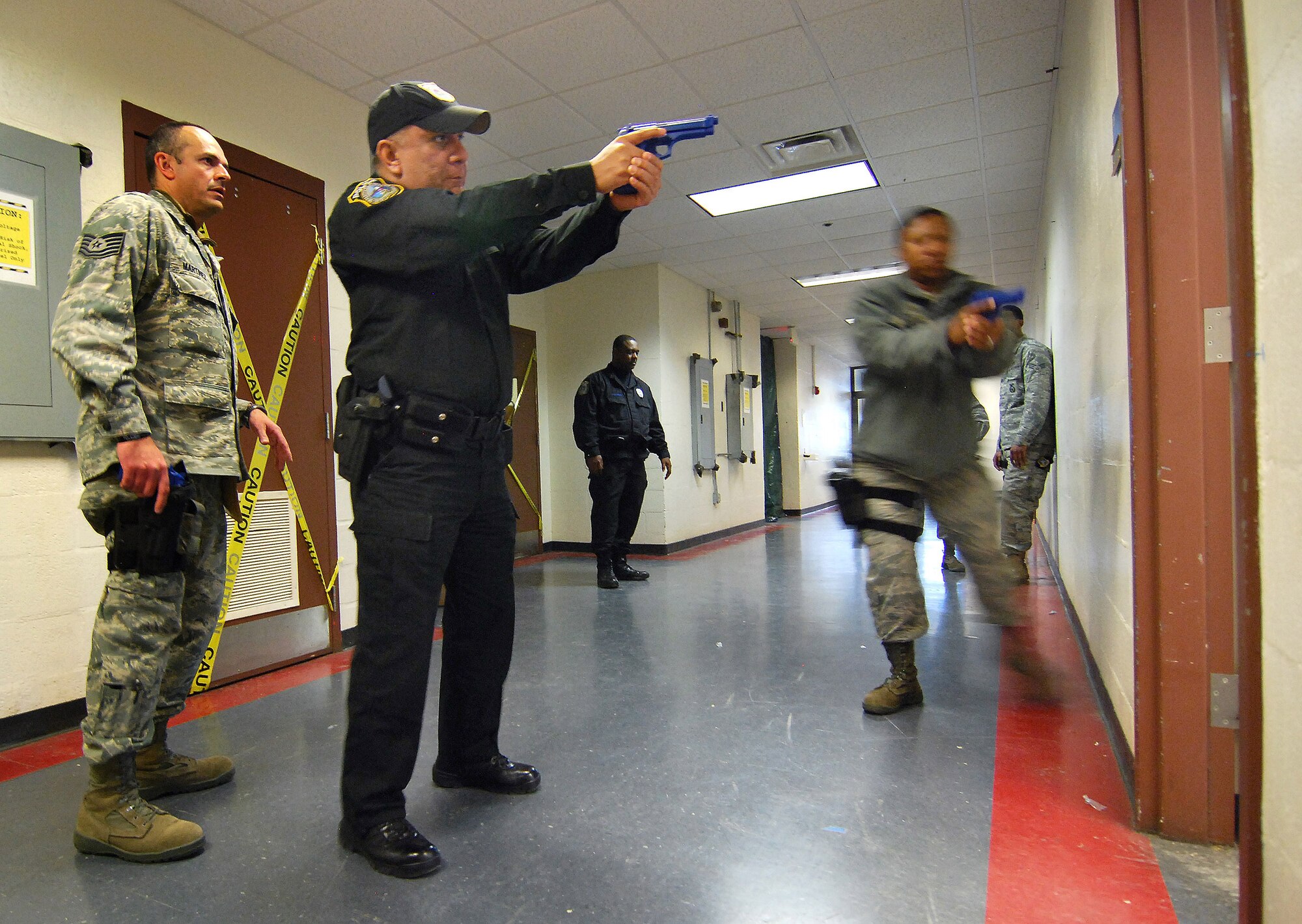 Tech. Sgt. Francisco Martinez from the 610th Security Forces Squadron, Joint Reserve Base Fort Worth, Texas, instructs Officer Juan Medina and Tech. Sgt. Doreen Clark-Blake on proper threshold entry during the Basic Active Shooter Course, Jan 26.  The 4-man training team came to Dobbins Air Reserve Base to provide critical training for the 94th Security Forces Squadron and other Dobbins area security personnel.  The two day course provides classroom and tactical instruction to first responders covering several shooting spree scenarios.   (U.S. Air Force photo/ Brad Fallin)