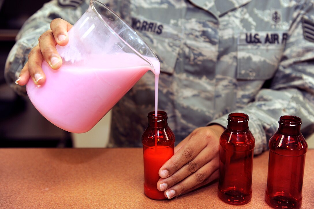 Staff Sgt. Shanika Morris, 28th Medical Support Squadron pharmacy frontline supervisor, pours “magic mouthwash” into 120 milliliter bottles at Ellsworth Air Force Base, S.D., Jan. 26, 2011.  “Magic mouthwash” is a mixture of lidocaine viscous, liquid antihistamine and liquid antacid, used to treat mouth sores and stomach ulcers. (U.S. Air Force photo/Staff Sgt. Marc I. Lane)