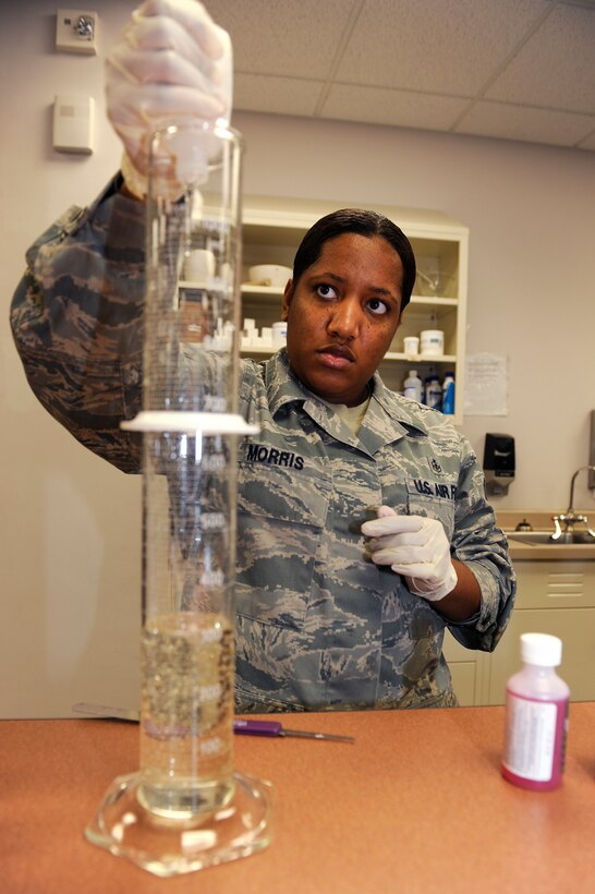 Staff Sgt. Shanika Morris, 28th Medical Support Squadron pharmacy frontline supervisor, pours lidocain viscous into a measuring cylinder at Ellsworth Air Force Base, S.D., Jan. 26, 2011.  Sergeant Morris has been in the U.S. Air Force for nine years and is originally from Roanoke, Va. (U.S. Air Force photo/Staff Sgt. Marc I. Lane)