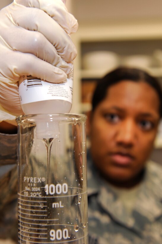 Staff Sgt. Shanika Morris, 28th Medical Support Squadron pharmacy frontline supervisor, pours lidocain viscous into a measuring cylinder at Ellsworth Air Force Base, S.D., Jan. 26, 2011.  Sergeant Morris created “magic mouthwash” by compounding the lidocain with a liquid antihistamine and liquid antacid.  “Magic mouthwash” is used to treat mouth sores and stomach ulcers. (U.S. Air Force photo/Staff Sgt. Marc I. Lane)