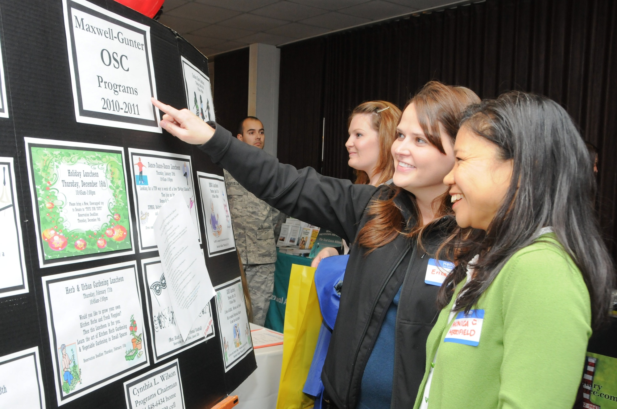 Erica Handly and Monica Merrifield, foreground, look at the volunteer opportunities available for spouses as part of the Maxwell-Gunter Officers’ Spouses’ Club Tuesday while attending the spouses’ call held at the Maxwell Event Center. (Air Force photo/Wendy Simonds)