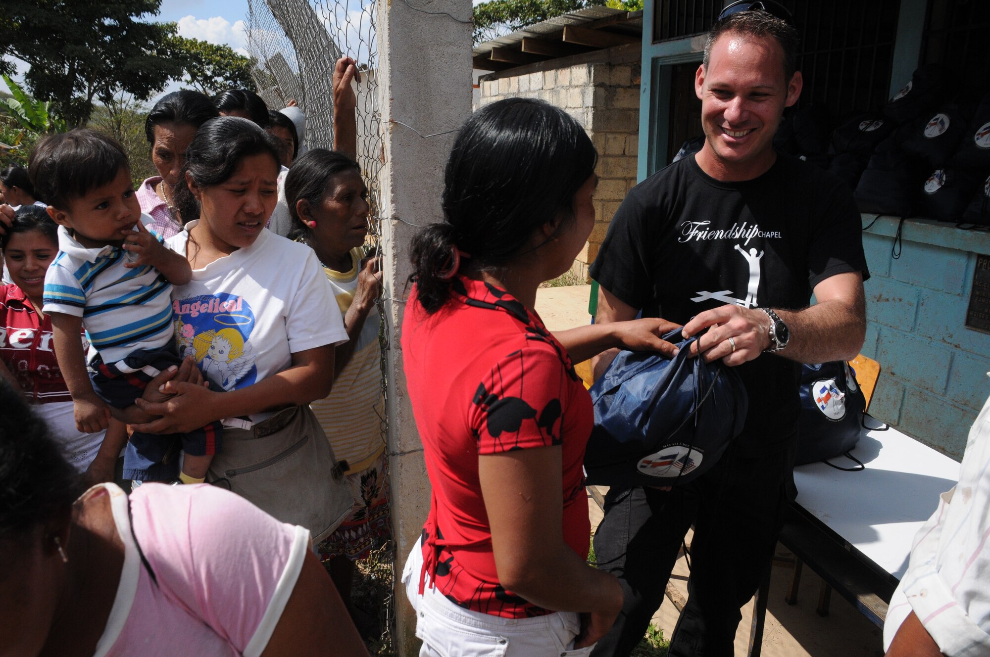 SOTO CANO AIR BASE, Honduras -- Capt. Charles Seligman, Joint Task Force-Bravo chaplain, hands a donation bag of food to a local villager following a Chapel Hike, Jan. 22 in which 107 JTF-B volunteers hiked to bring donations of food and hygiene items to Las Delicias and Guayabal villages . (U.S Air Force photo/Staff Sgt. Kimberly Rae Moore)
