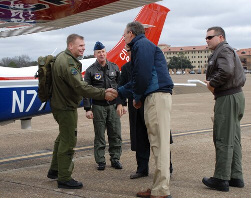 Brig. Gen. Christopher Coates (left), Continental United States North American Aerospace Defense Command Region deputy commander, is greeted by John Salvador (second from right), Civil Air Patrol National Headquarters assistant executive director, at CAP’s National Headquarters at Maxwell Air Force Base, Ala., Jan. 26. General Coates presented CAP with five Geospatial Information Interoperability Exploitation Portable go kits courtesy of Air Forces Northern to enhance their mission capability and to show gratitude for their support. (Civil Air Patrol photo by Steve Cox)