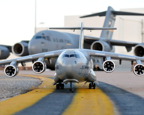 A remote controlled model C-17 Globemaster sits on the flight line in front of a full sized C-17 at Altus AFB, 26 Jan.  The model was built by Tech. Sgt. Phil Landram 54th Air Refueling Squadron and is part a new RC model plane club starting on base as an after school youth program.  This particular model is named "Spirit of Jessie" and displays the Altus AFB tail flash. (U.S. Air Force photo by Master Sgt. Brian Boisvert 97th Air Mobility Wing)
