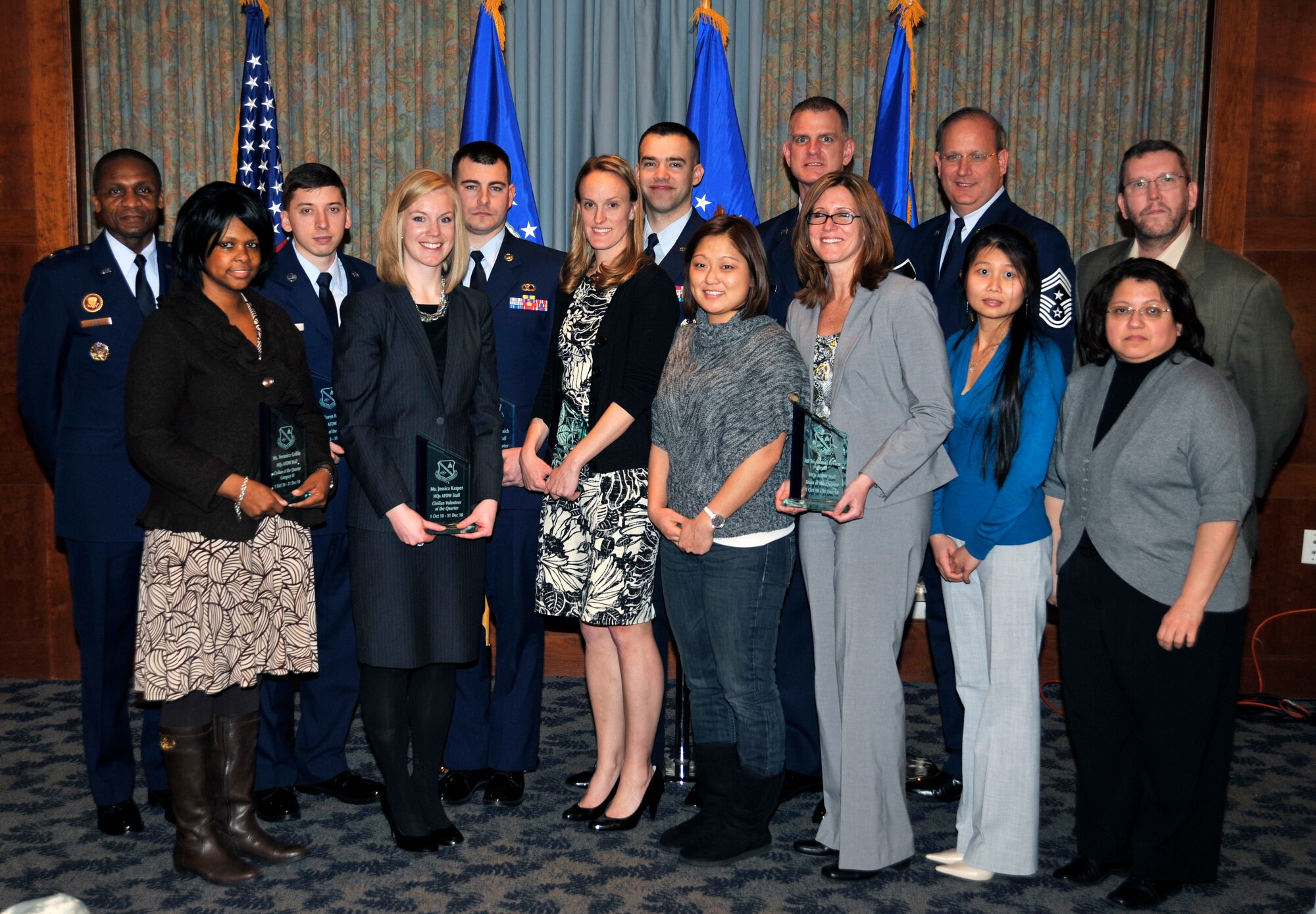 AFDW Commander Maj. Gen. Darren W. McDew and Command Chief Master Sgt. Pat Battenberg stand with quarterly award winners at The Club on Andrews, Jan 21, 2010. Three contract specialists and two JAG Airmen walked away with five total awards. AFDW Chief of Financial Operations Richard Dillow led a team of tri-annual review financial specialists to a Team of the Quarter award as well. All quarterly award winners will be up for AFDW annual awards. 