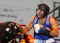 Forrest Booker (right), RAF Alconbury, England, knocks down during his civilian opponent during the Air Force Box-offs super heavyweight bout. In his first official amateur contest, Booker stopped his opponent in the first round. (U.S. Air Force photo/Robbin Cresswell)