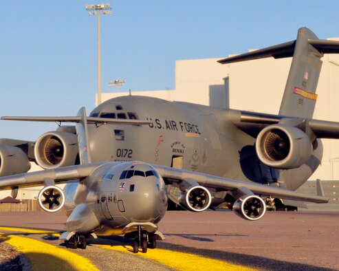 A remote controlled model C-17 Globemaster sits on the flight line in front of a full sized C-17 at Altus AFB, 26 Jan.  The model was built by Tech. Sgt. Phil Landram 54th Air Refueling Squadron and is part a new RC model plane club starting on base as an after school youth program.  This particular model is named "Spirit of Jessie" and displays the Altus AFB tail flash. (U.S. Air Force photo by Master Sgt. Brian Boisvert 97th Air Mobility Wing)
