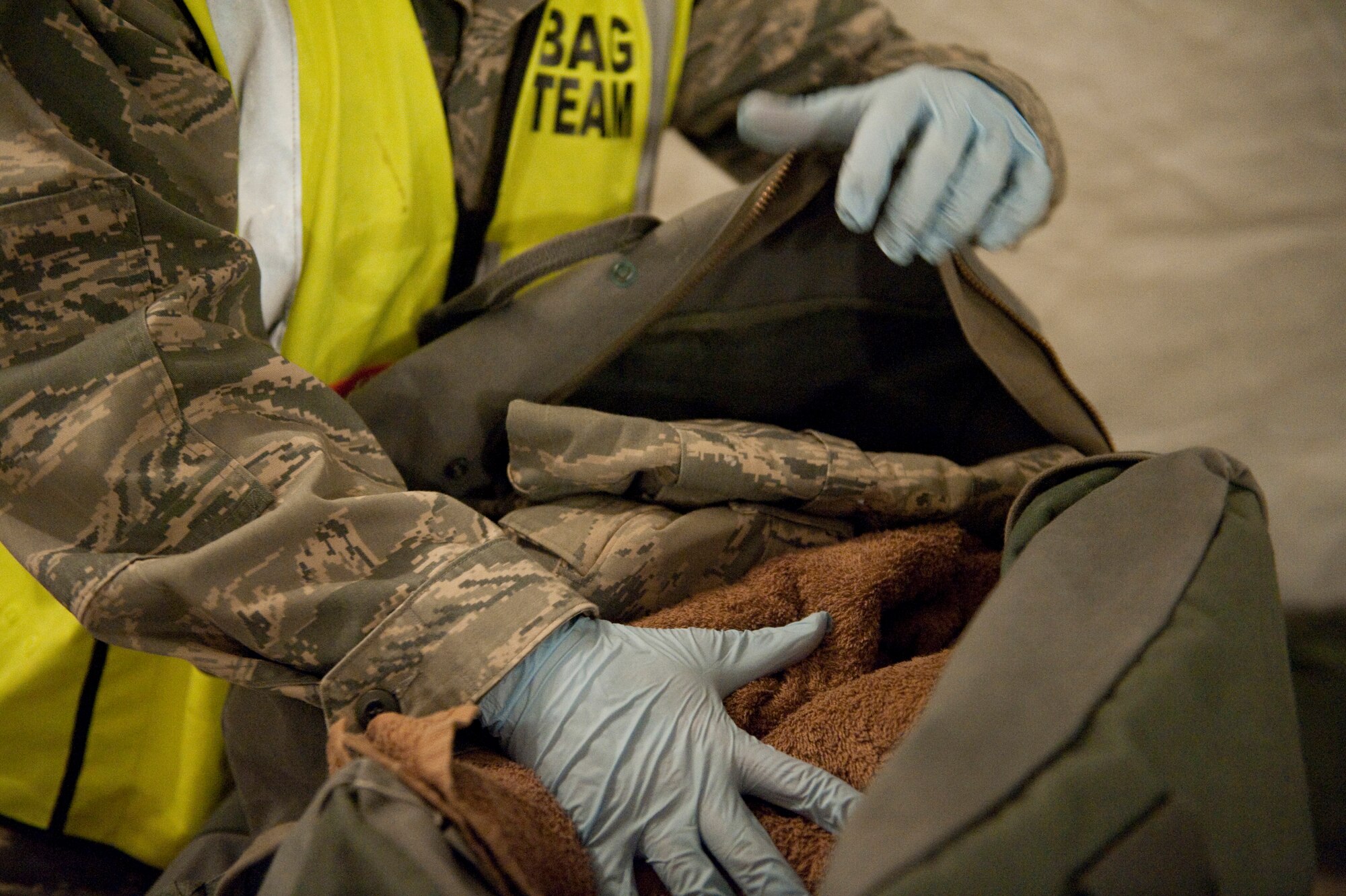 HOLLOMAN AIR FORCE BASE, N.M. -- Airman 1st Class Robert Skvarla, 49th Force Support Squadron, inspects a mobility bag during a base exercise Jan. 25, 2011. The bag team inspects each Airman's bag for completeness and readiness for deployment. This specific exercise is designed to test an Airman's ability and readiness to deploy, and helps to prepare the base for its upcoming Operational Readiness Inspection. (U.S. Air Force photo by Senior Airman Veronica Stamps / Released)