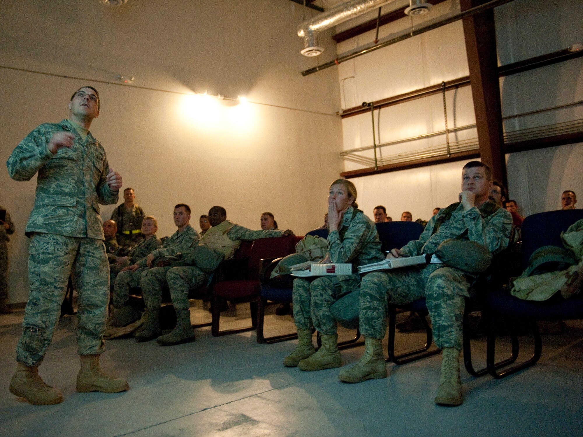 HOLLOMAN AIR FORCE BASE, N.M. -- Capt. Dean Korsak, 49th Wing Legal office, briefs Airmen during a base exercise Jan. 25, 2011, on the legal assistance available to them. During the exercise, Airmen selected to deploy must process through the personnel deployment facility to ensure they are prepared. These exercises are designed to test an Airman's ability and readiness to deploy. (U.S. Air Force photo by Senior Airman Veronica Stamps / Released