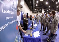 Senior Master Sgt. Don Friemel and Sharon Witter, both with the 802nd Force Support Squadron, lead Airmen in a game of Airman and Family Readiness Jeopardy at the Air Education and Training Command Symposium and Exposition Jan. 20. More than 3,500 Airmen, civilians, civic leaders, sister-service members and foreign officials gathered here for the two-day event held at the Henry B. Gonzalez Convention Center. (U.S. Air Force photo/Robbin Cresswell)