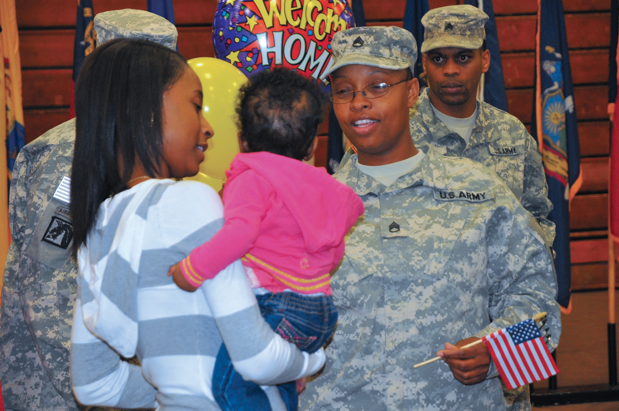 Staff Sgt. Leslie McQune, a personnel noncommissioned officer with the 510th Human Resource Company, Special Troops Battalion, 7th Sustainment Brigade, is greeted by friends at Fort Eustis’ Anderson Field House during the unit’s welcome home ceremony. McQune, 39, is a native of South Carolina and has served in the Army for 14 years; McQune has been assigned to the brigade since 2006. Returning home from Kuwait marks the completion of her third deployment.
