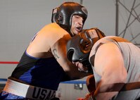 Air Force heavyweight Kent Brinson tangles with Owaldo Escamilla during his bout at the Bennett Fitness Center Jan. 22. Brinson earned a unanimous decision from the judges. (U.S. Air Force photo/Robbin Cresswell)