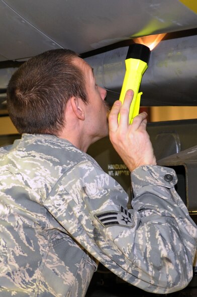 Senior Airman Bryan Hylton, 2nd Munitions Squadron performs a Conventional Air Launched Cruise Missile download from a launcher on Barksdale Air Force Base, La., Jan. 26. The mission of the 2 MUNS is to provide fully-mission capable cruise missiles and bombs whenever called upon. (U.S. Air Force photo/Senior Airman Brittany Y. Bateman)(RELEASED)